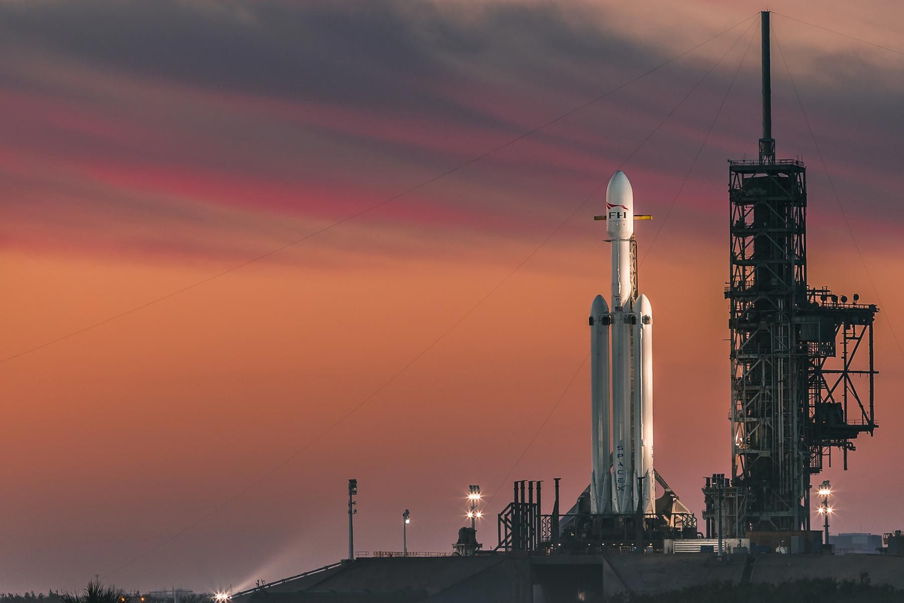Eine Rakete steht bei Sonnenuntergang zum Liftoff bereit.